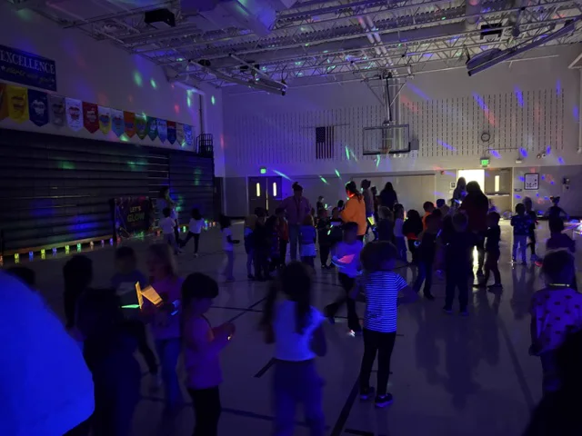 Families and students gathered for an indoor school celebration